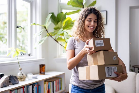 Happy woman at home receiving packages in the mail Happy woman at home receiving packages in the mail