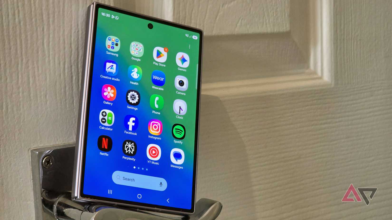 The Samsung Galaxy Z Fold 8 leaning on a door handle.