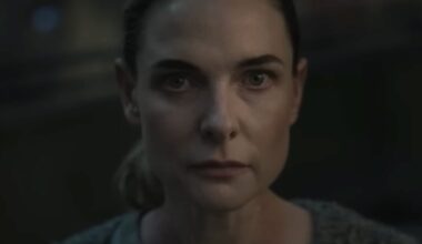 close up of woman with hair pulled back in a ponytail looking resolved