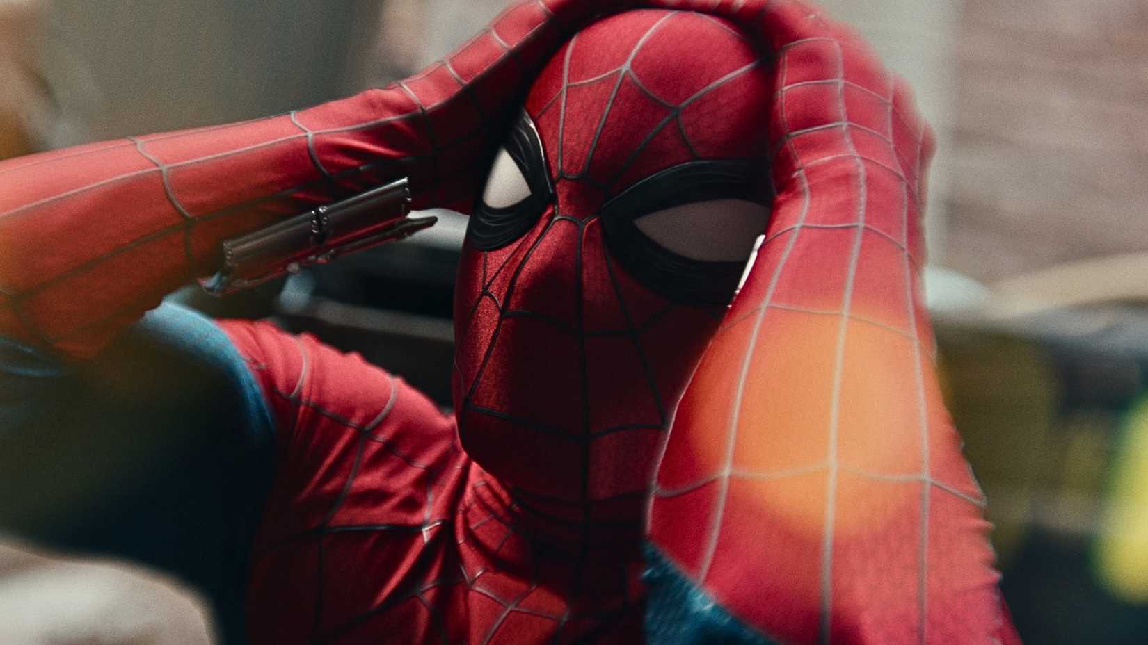 Tom Holland's suited up superhero holding his head in Spider-Man: Brand New Day