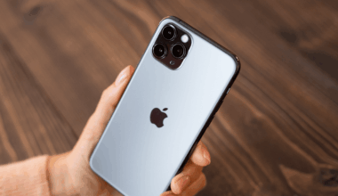 A hand holds an iPhone.