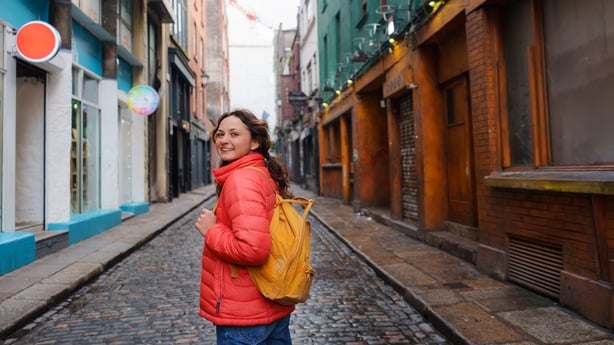 Cheerful woman walking In Dublin old town