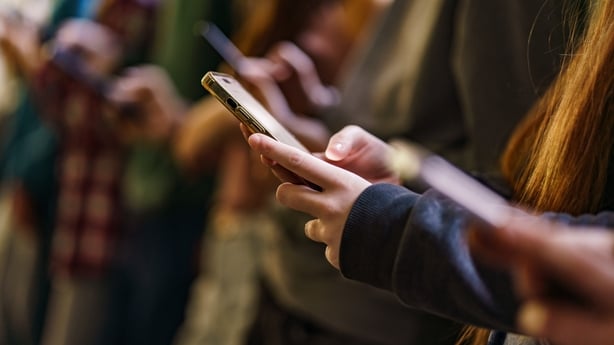 Close-up of mobile phones in children's hands in the school
