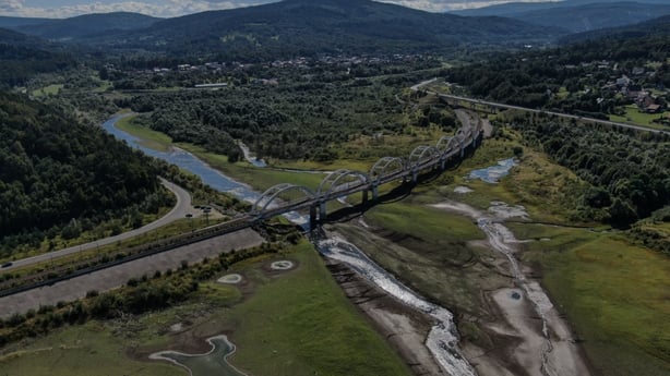An aerial view shows railway bridge above the almost dried Skawa river amid drought conditions in Zembrzyce, Poland