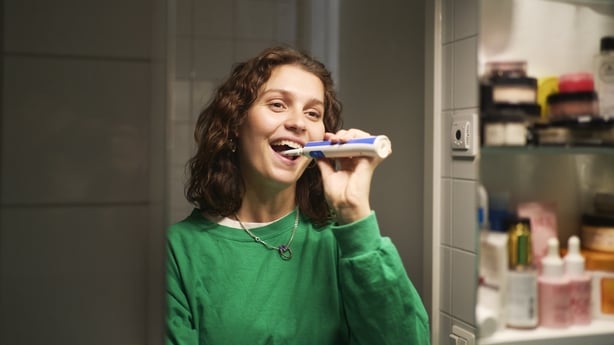 Young woman brushing her teeth
