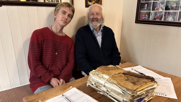 Willie Daly and his grandson, Marlon, sit at a table.