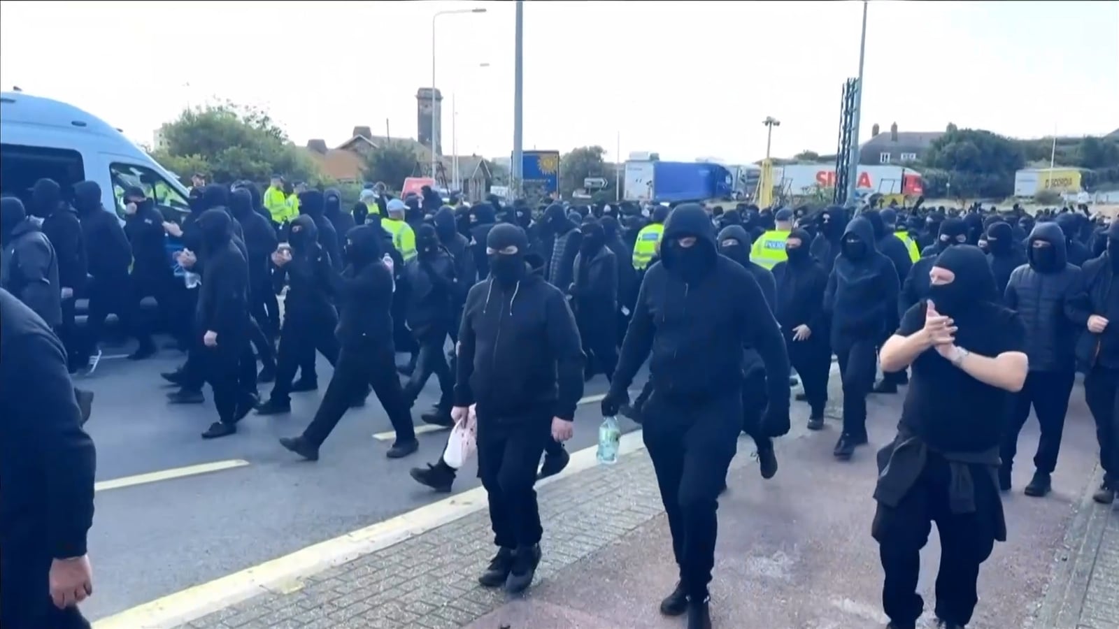 Masked protesters hold 'anti-illegal migrant' demo in UK