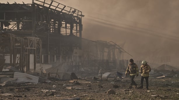 Emergency service workers and local authorities respond to a Russian strike in Ukraine