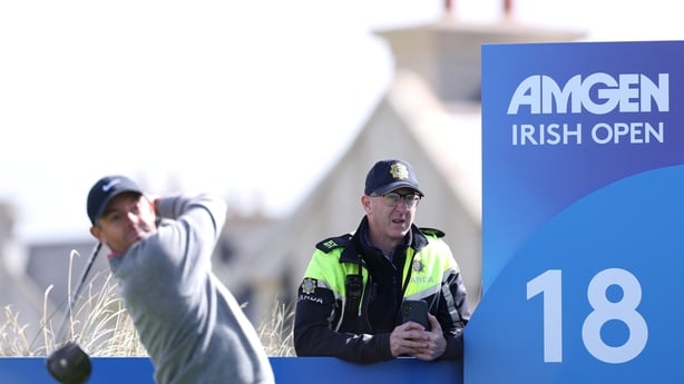 A Garda officer watches as Rory McIlroy of Northern Ireland tees off on the 18th hole during a practice round, prior to the Amgen Irish Open at Trump International Golf Links in Doonbeg on September 08, 2026 in Clarecastle, Ireland.