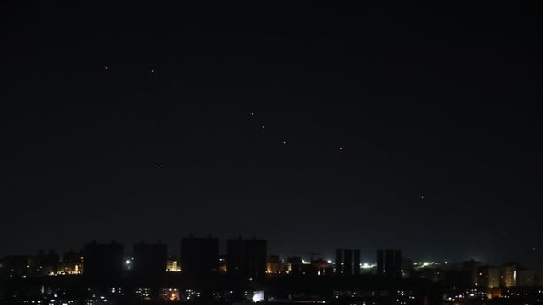 Missiles launched from Iran and interceptions by Jordanian air defense systems are visible in the night sky from Damascus in Syria.