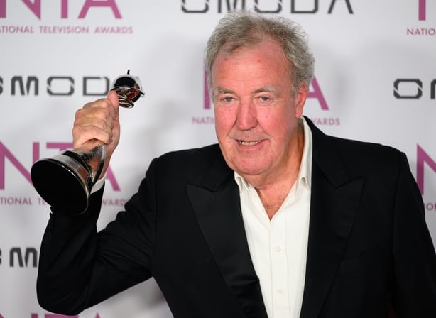 TV presenter wins award and stands on red carpet