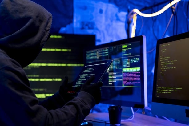 Hacker, IT and person with code on computer, programming and phishing scam with malware or virus. Hacking, system glitch and cloud computing error in dark room, cyber crime and cybersecurity fail