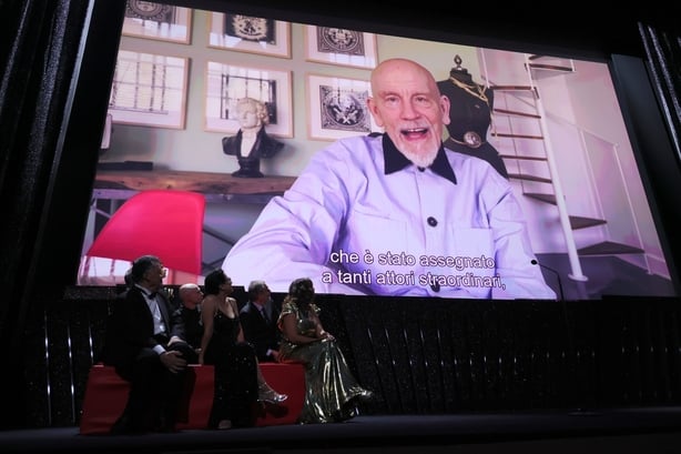 John Malkovich is seen on the screen during a video message as he receives the Coppa Volpi for Best Actor for Wild Horse Nine at the Venice Film Festival on 12 September, 2026. (Photo by Vittorio Zunino Celotto/Getty Images)