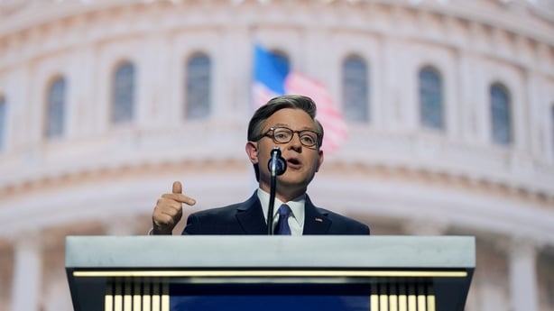 Mike Johnson speaking at a podium during the Republican Midterm Convention