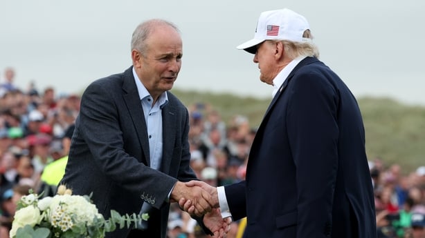 U.S. President Donald Trump (R) shakes hands with Irish Taoiseach Micheal Martin ahead of presenting the winner's trophy to Ireland's Shane Lowry (not pictured) on the final day of the Irish Open on September 13, 2026 in Doonbeg, Ireland. U.S. President Donald Trump is making a two-day visit to Irel