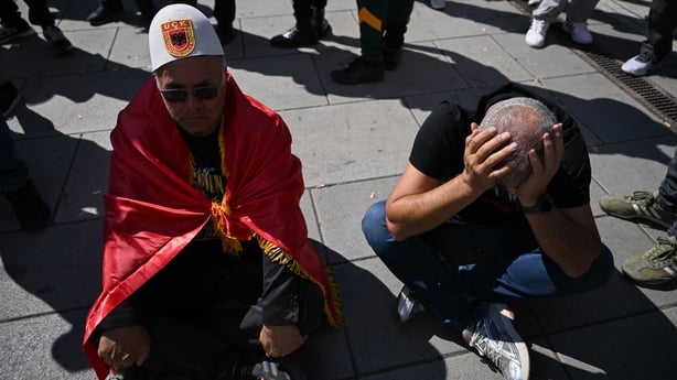 Protesters sit outside the headquarters of the EU Rule of Law Mission (EULEX) in Pristina