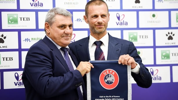 UEFA president Aleksander Ceferin (R) and the president of the Football Federation of Kosovo Fadil Vokrri (L) pose with a UEFA flag following a press conference on August 17, 2017 in the capital Pristina during Ceferin's first visit to Kosovo.