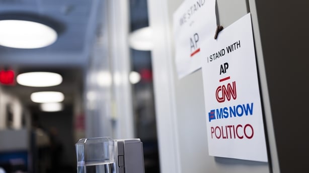 Signs of support for AP, CNN, MS NOW and POLITICO hang on the White House grounds