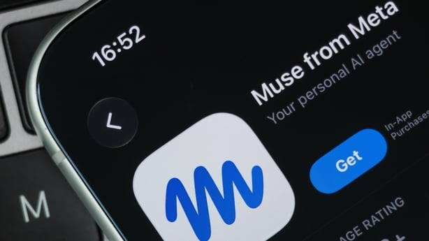 In this photo illustration, the App Store listing for Meta's Muse AI assistant is displayed on a smartphone resting on a laptop keyboard