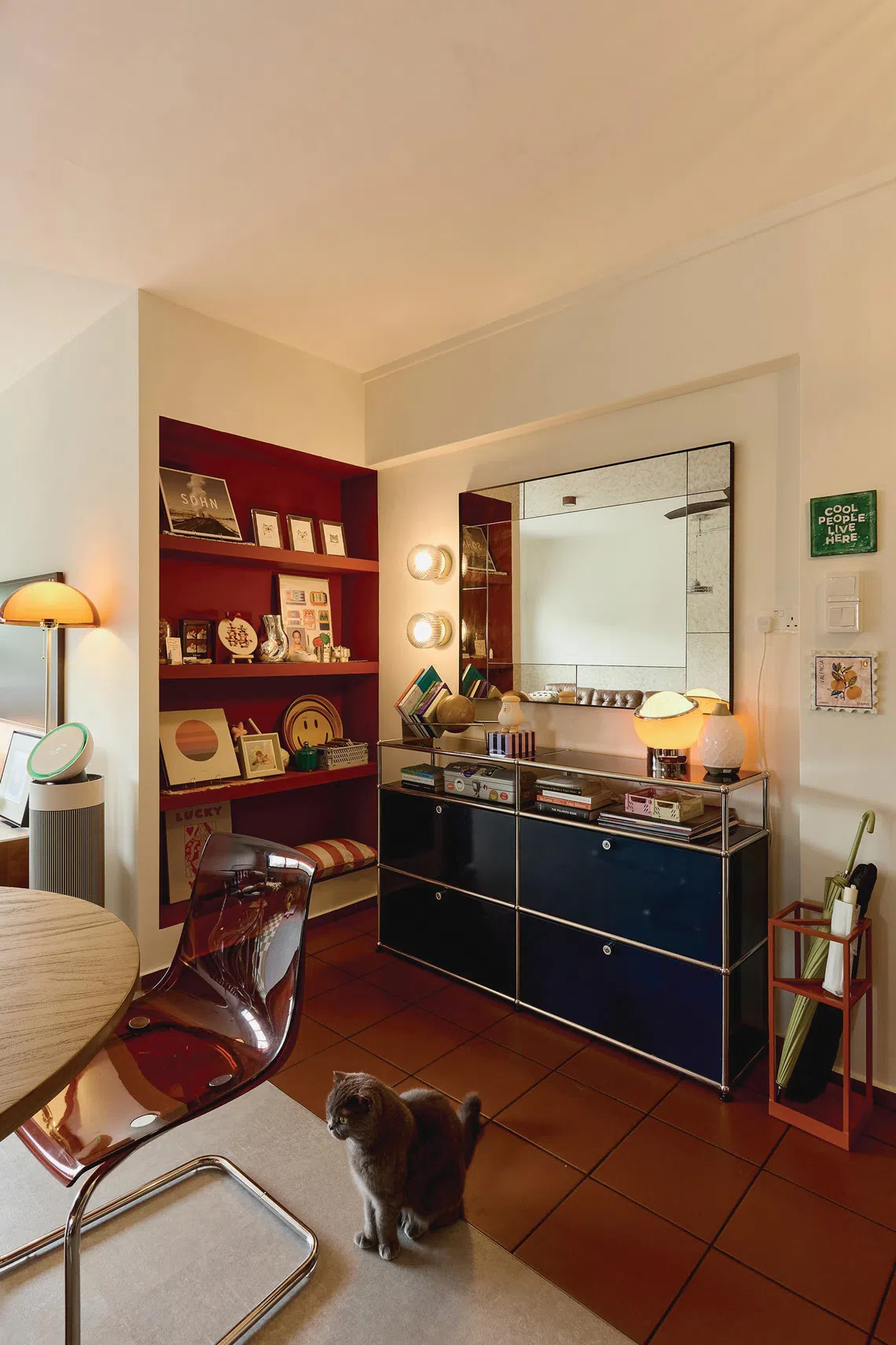 In front of the dining table is a metal bookshelf, lined with a selection of tomes collected on Loh’s travels.