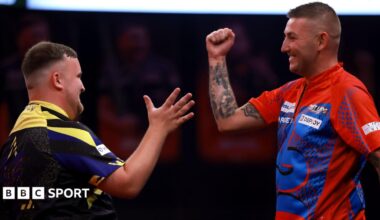 Luke Littler and Nathan Aspinall prepare to shake hands at the end of their match