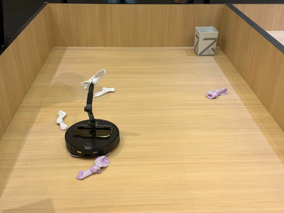 Roborock displayed the Saros Z70, a vacuum fitted with a robotic arm that can pick up socks or slippers left on the floor, move them aside, and then clean the space beneath.
