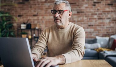 Man working on a laptop from home.