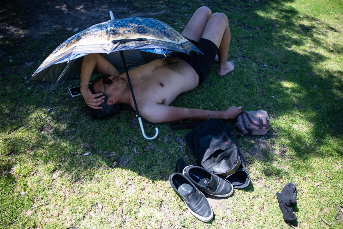 Salvador Rivera relaxes in the shade at Echo Park.