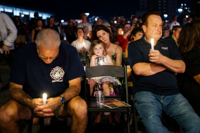 people-hold-candles-during-the-brooklyn-911-wall-of-remembrance-candlelight-ceremony-in-coney-island-on-the-eve-of-the-25th-anniversary-of-the-sept-11-world-trade-center-attacks-thursday-sept-10