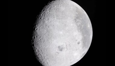 Surface of the moon with black all around.