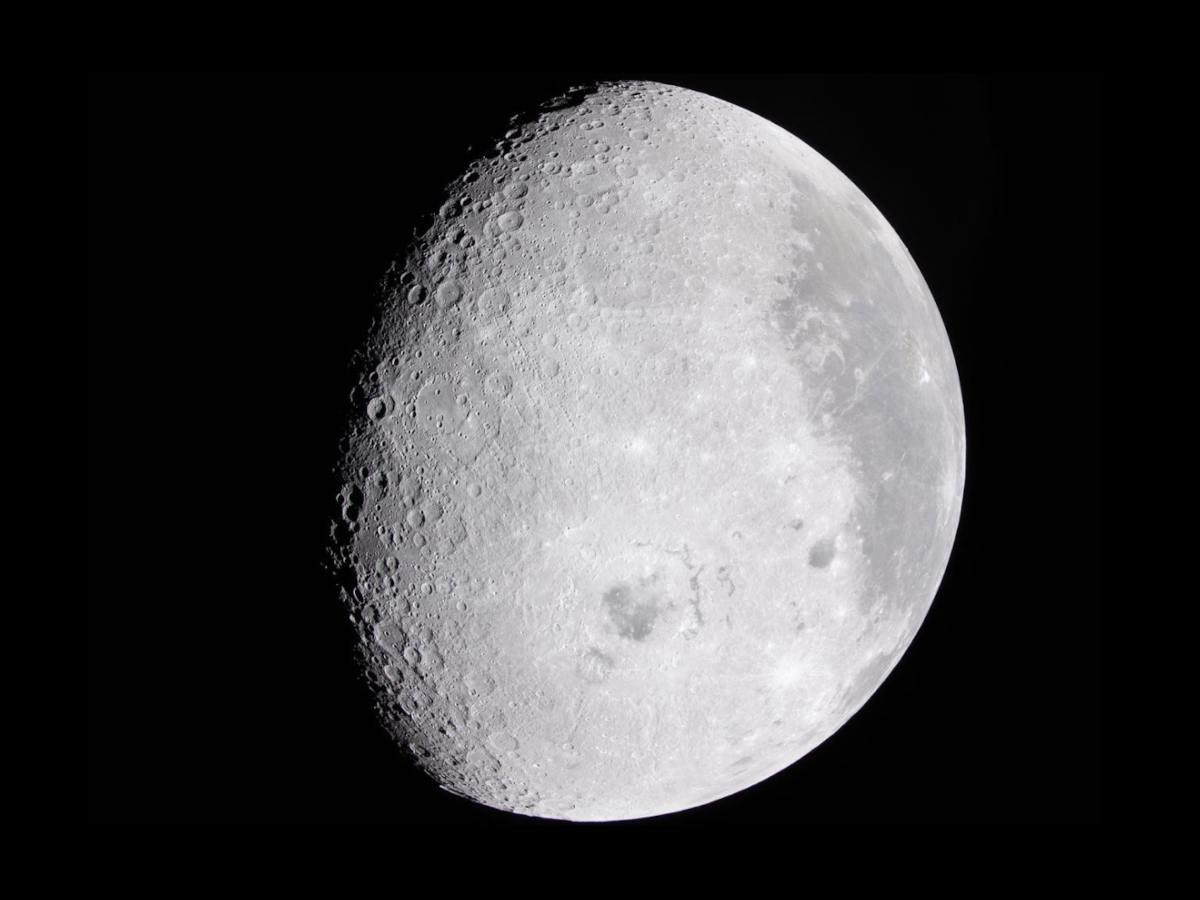 Surface of the moon with black all around.