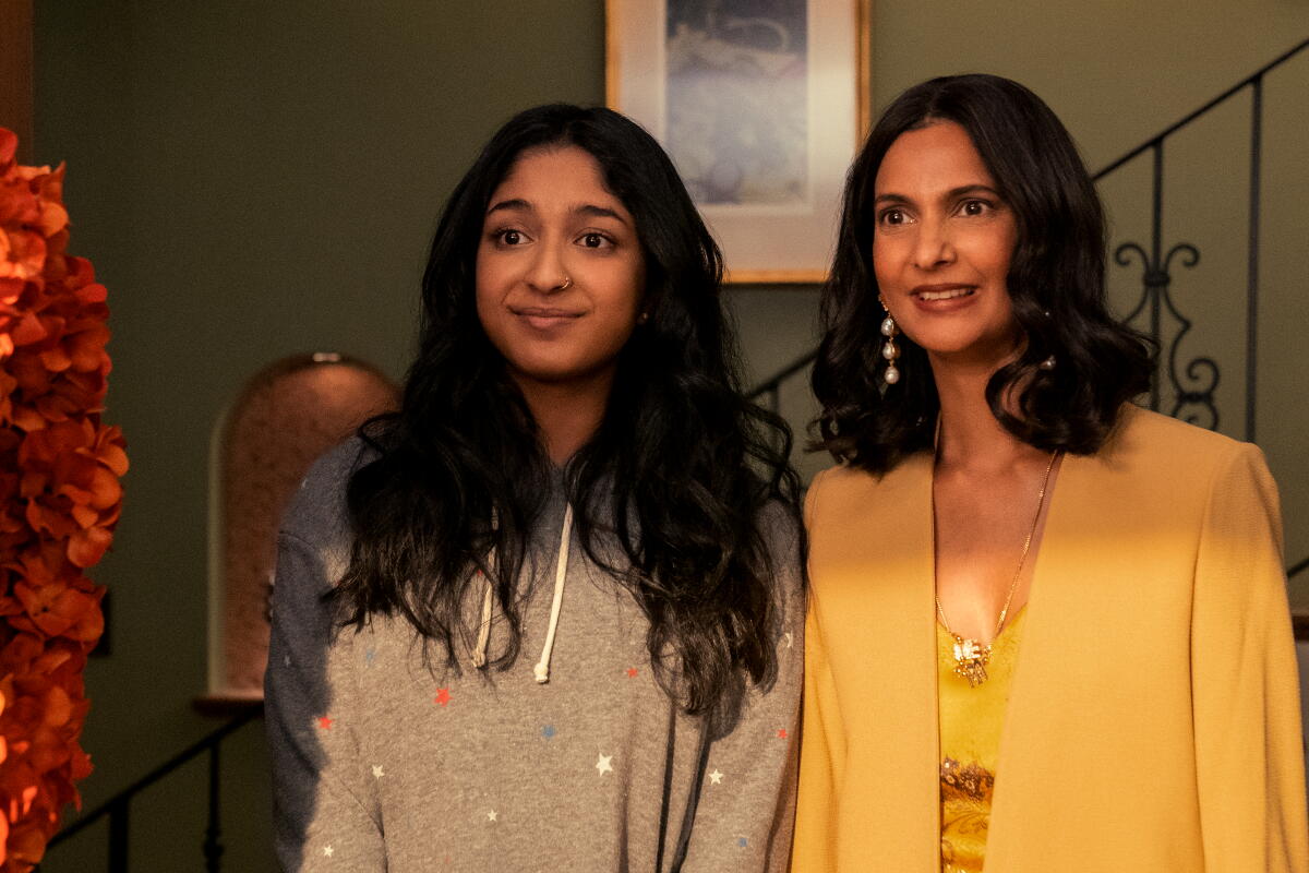 A teen girl and her mother standing side by side