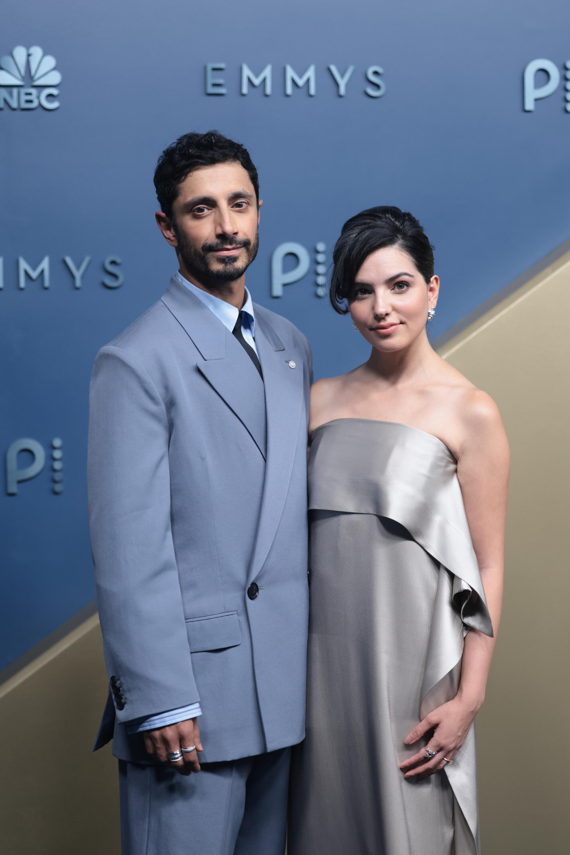 Riz Ahmed and Fatima Farheen Mirza pose on the Emmys blue carpet. 