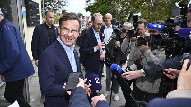 Sweden's Prime Minister Ulf Kristersson, leader of the conservative Moderates, speaks with journalists in front of a polling station in Strangnas near Stockholm, during Sweden's general election on September 13, 2026. Polling stations opened in Sweden in what is expected to be a close general electi