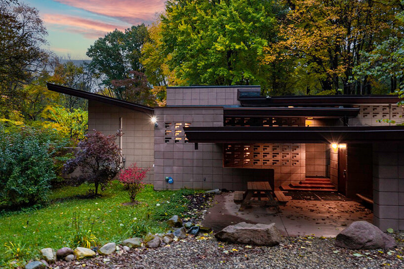 cantilevered roof extends over frank lloyd wright’s concrete usonian house
