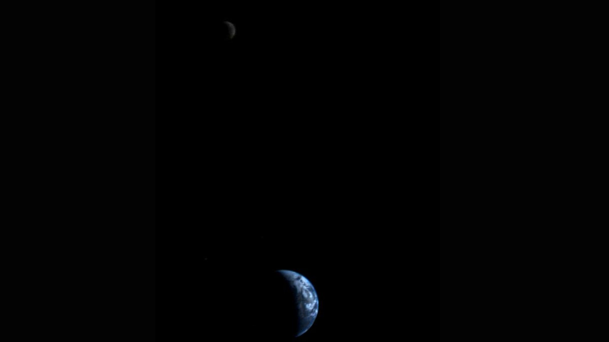 This picture of a crescent-shaped Earth and Moon, the first of its kind ever taken by a spacecraft, was recorded Sept. 18, 1977, by NASA's Voyager 1 when it was 7.25 million miles (11.66 million kilometers) from Earth.