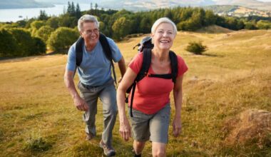 Senior couple climbing hill.