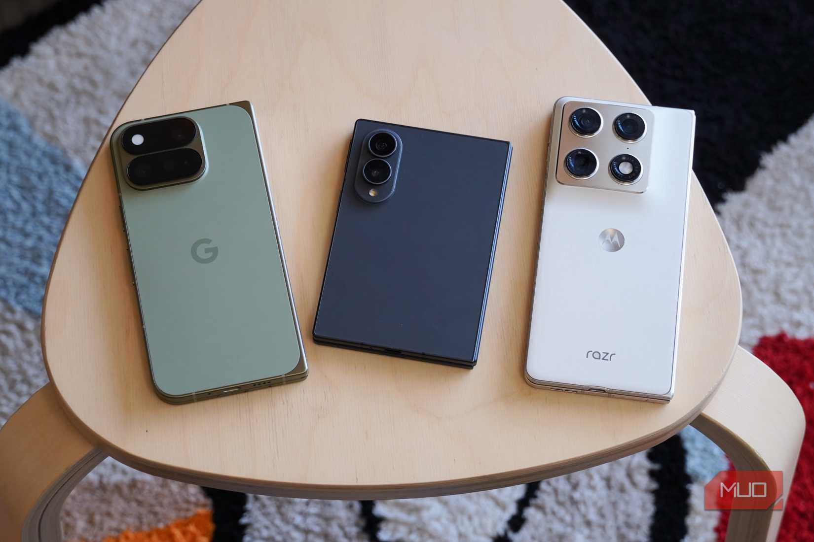 The Google Pixel 11 Pro Fold, Samsung Galaxy Z Fold 8, and Motorola Razr Fold on a table.