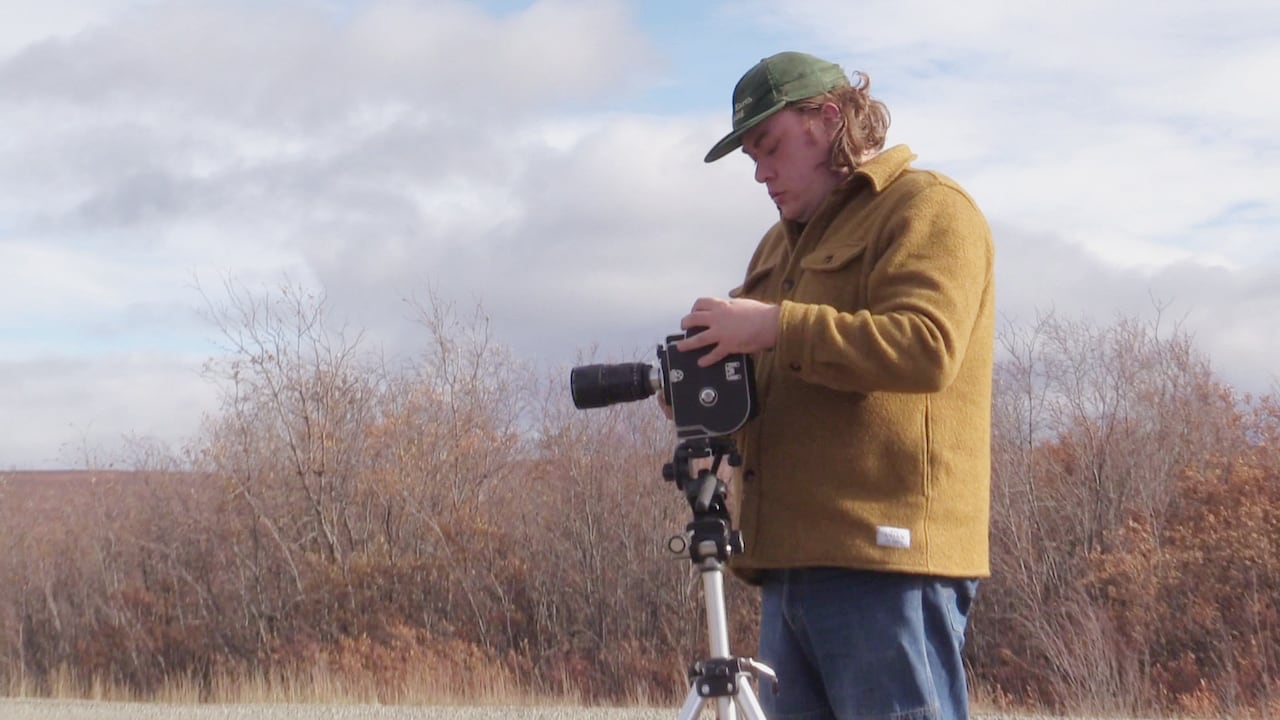 Luke Pardy during the Dawson Film Lab 2026, on the Dempster highway with a Bolex camera.