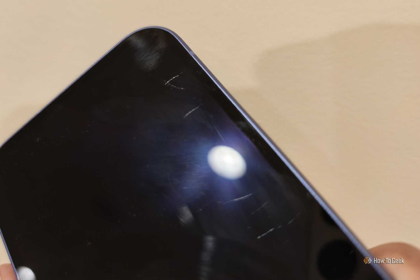 Scratches on the screen of a Google Pixel 10a.