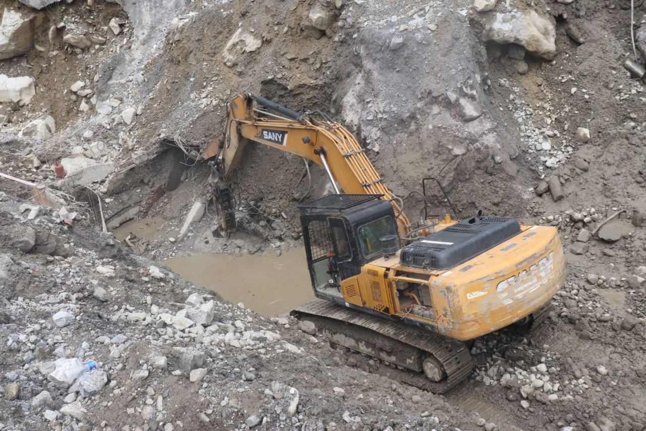 The Nepali army uses an excavator during a search and rescue operation outside a tunnel near the Hydropower site on Wednesday.