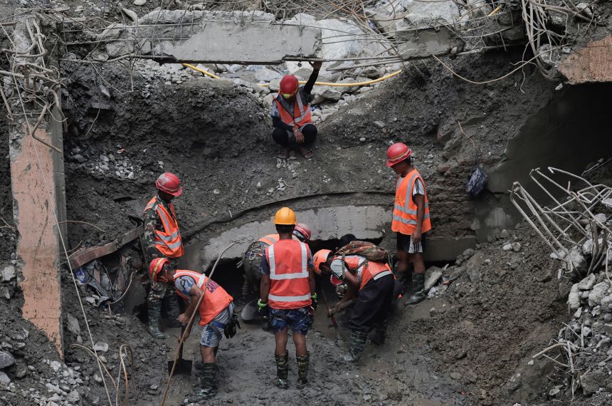 Rescue team members work to enter the tunnel at the Upper Trishuli 3A Hydropower Station as they search for survivors and retrieve bodies in Rasuwa, Nepal, on Thursday.