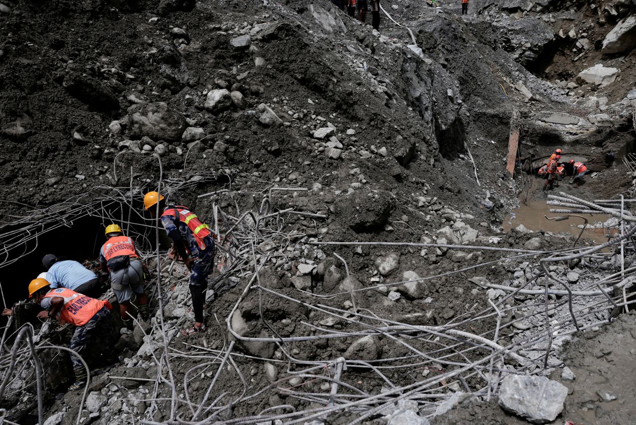 Rescueers work to enter the tunnel.