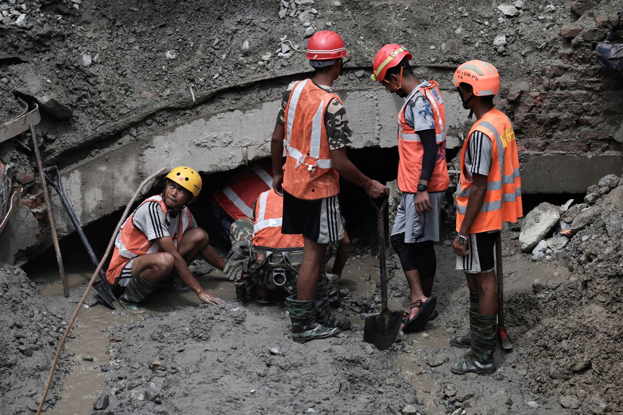 Rescue team members at a tunnel entrance at the Trishuli 3A hydropower plant as they search for survivors in Rasuwa, Nepal, on Thursday.