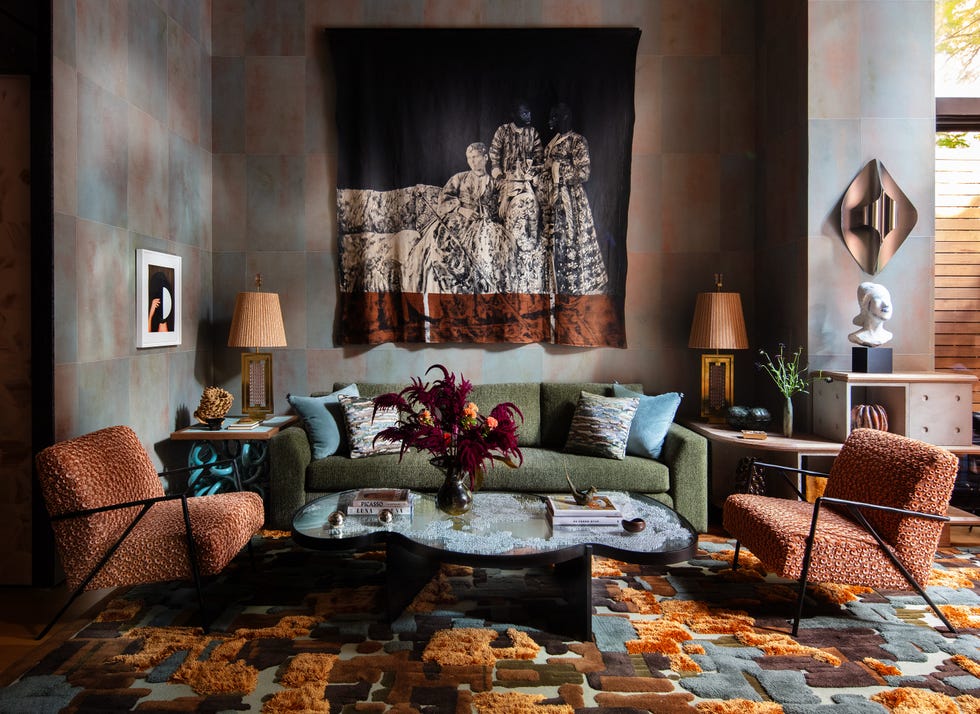 Modern living room featuring a tapestry, colorful furnishings, and decorative elements on a stylish rug.