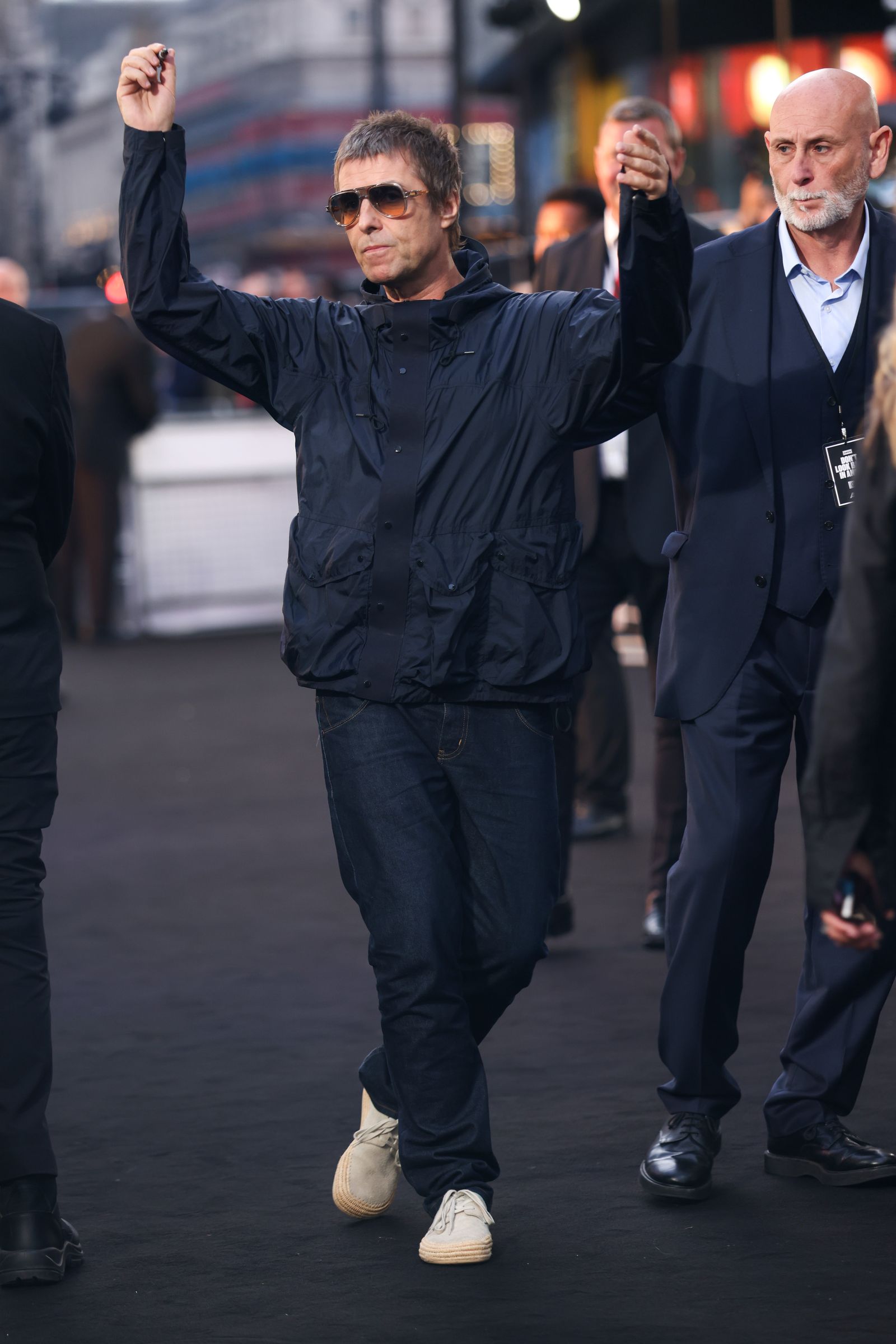 Image may contain Liam Gallagher Clothing Coat Head Person Face Adult Formal Wear Suit Jacket and Happy