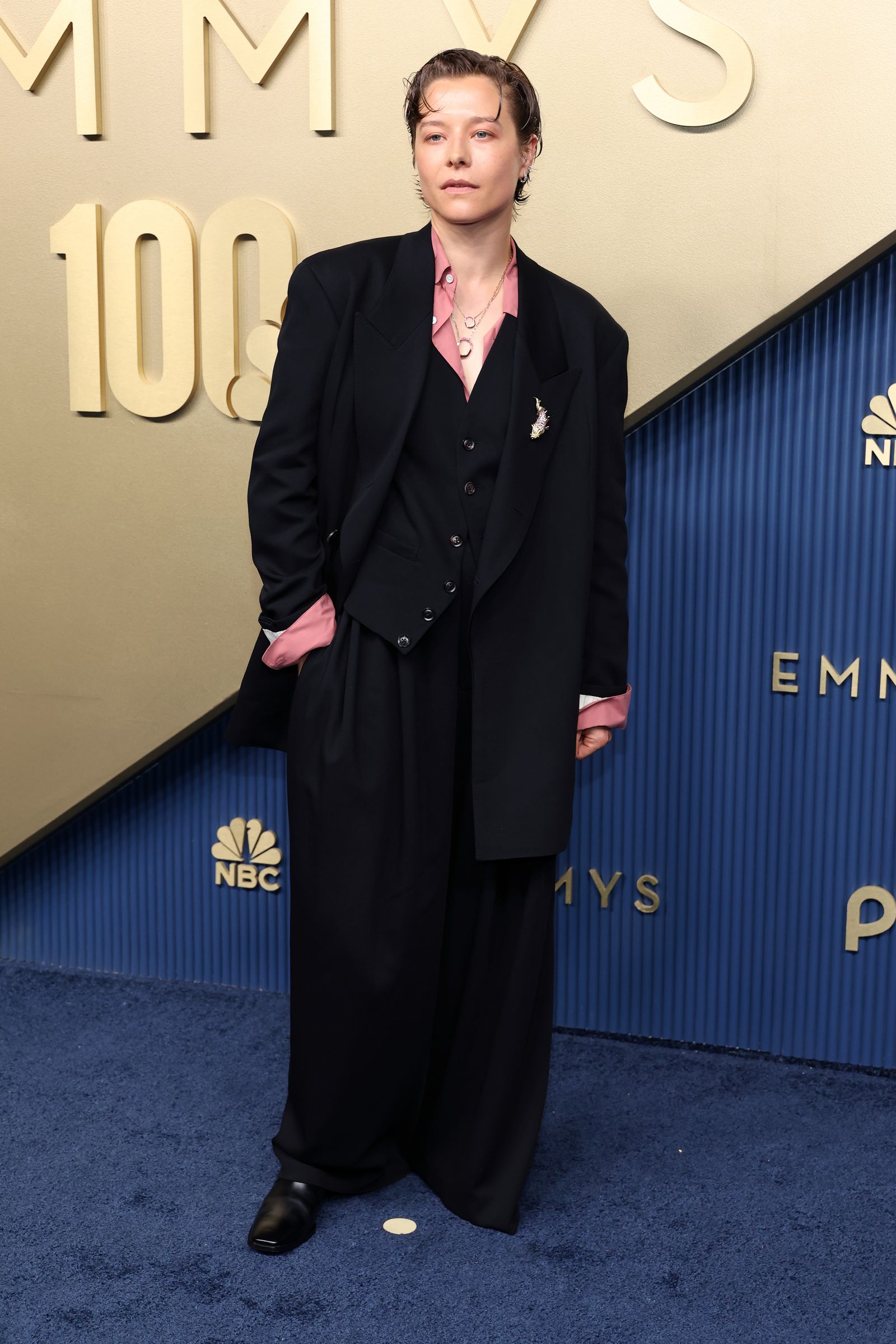 Image may contain Clothing Formal Wear Suit Coat Person Standing Adult and Fashion