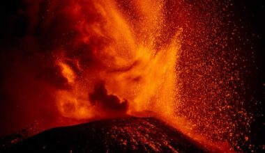 Mount Etna volcano erupting orange lava