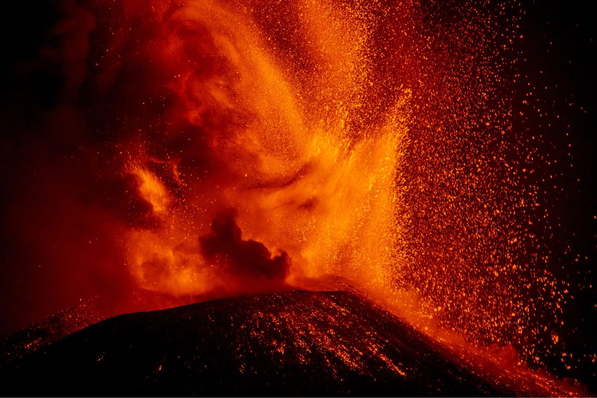 Mount Etna volcano erupting orange lava