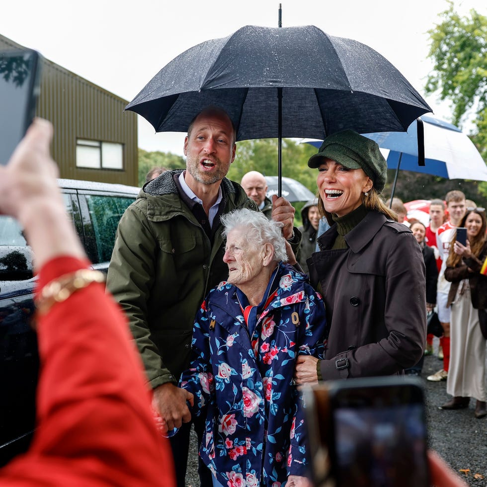 The Prince And Princess Of Wales Visit The Isle Of Bute rothesay, isle of bute, scotland september 17: prince william, prince of wales, and catherine, princess of wales, pose with 95 year old jenny salli while visiting bute shinty club in rothesay, during a royal visit to the isle of bute on september 17, 2026 in rothesay, isle of bute, scotland. the prince and princess of wales, who also hold the titles of the duke and duchess of rothesay, visited the island to celebrate community, connection and volunteering. (photo by jeff j mitchell/getty images)